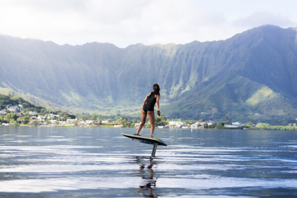 Fliteboard PRO effortlessly gliding on a crystal clear lake, showcasing its sleek design and unmatched performance amidst pristine waters.