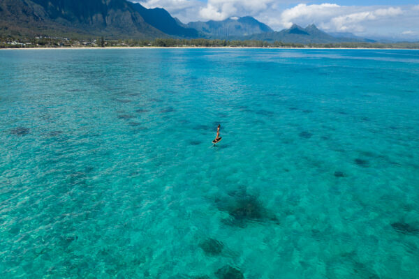 Fliteboard PRO gliding effortlessly over the pristine, crystal clear lake, showcasing the epitome of exhilarating water sports.