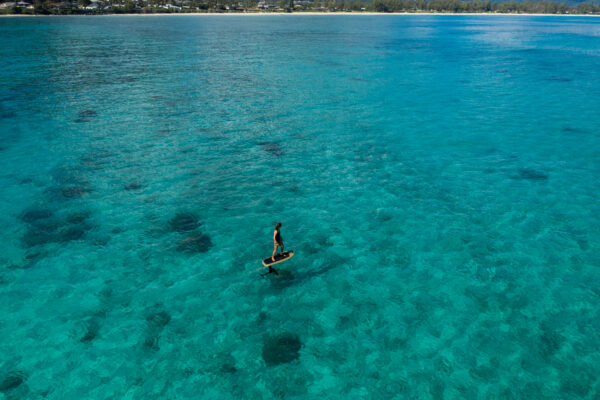 Fliteboard gracefully skimming the surface of a serene lake, surrounded by breathtaking natural beauty.