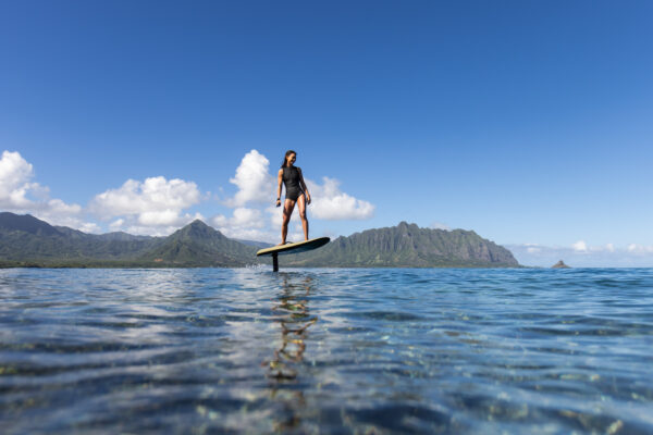 A woman soaring high on the Fliteboard, embracing the freedom and power of hydrofoil flight.