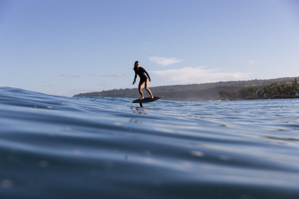 Fliteboard PRO for Women - Effortlessly gliding on the serene lake, embracing the freedom and beauty of hydrofoil adventure.