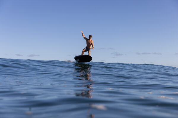 Man riding Fliteboard ULTRA, gliding effortlessly across the water with a sense of excitement and freedom.