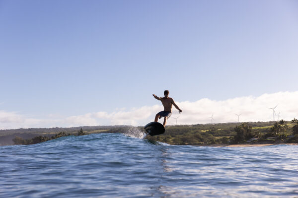 A man rides the Fliteboard ULTRA, effortlessly gliding across the water's surface, experiencing the pure joy of aquatic adventure.