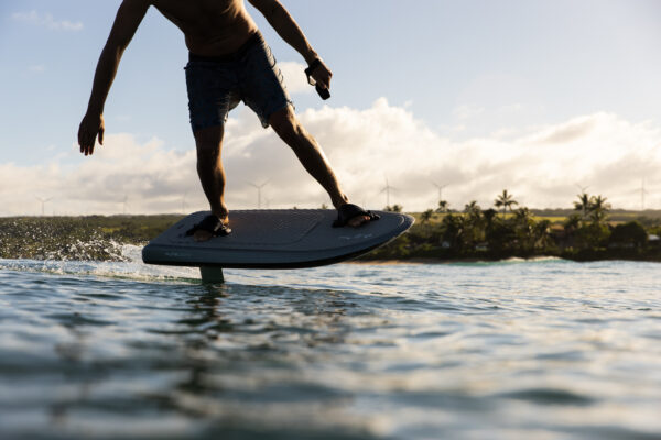 A sleek, electric hydrofoil surfboard called the Fliteboard ULTRA. It features a carbon fiber board with a streamlined design and a hydrofoil attached underneath. The board is powered by a silent electric motor and battery, allowing riders to effortlessly glide above the water's surface. The Fliteboard ULTRA provides an exhilarating and eco-friendly water sport experience.