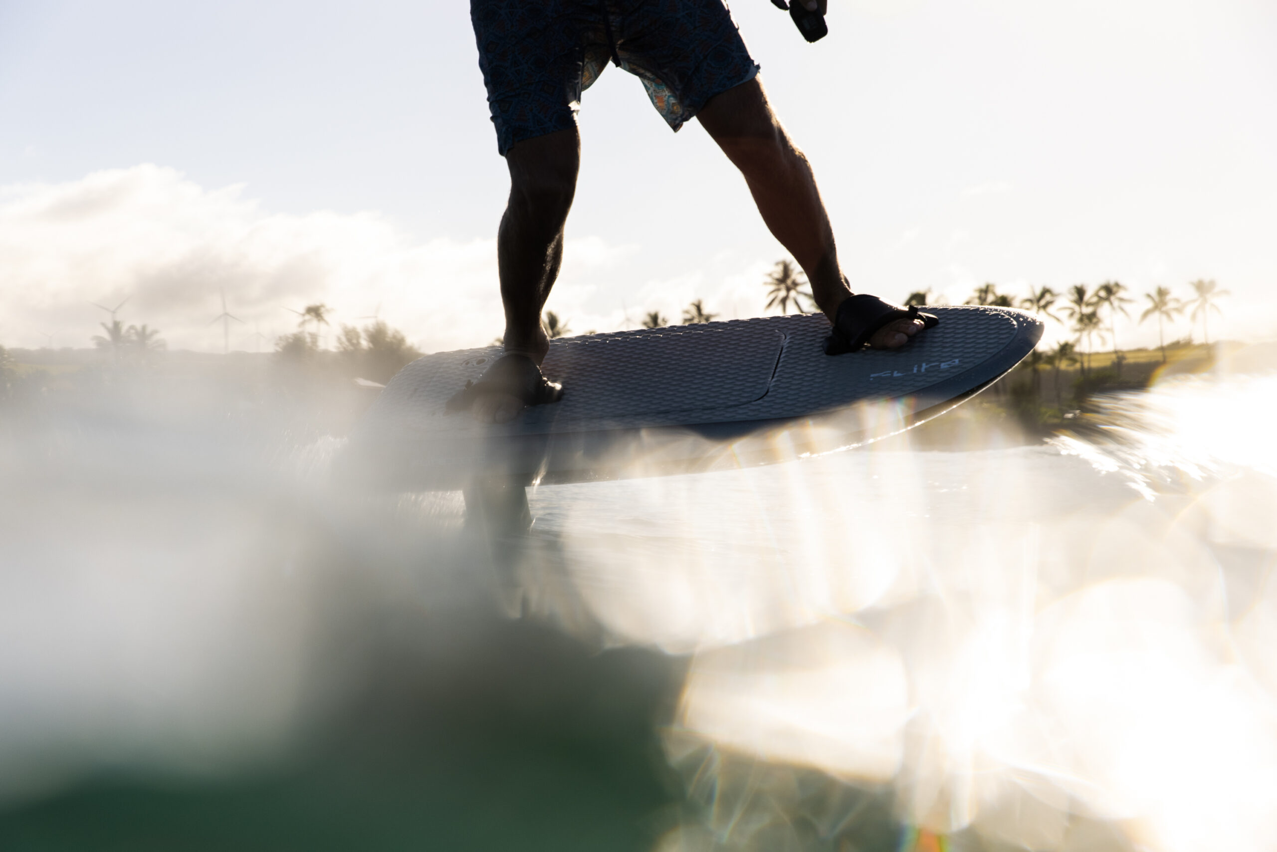 A sleek, electric hydrofoil surfboard called the Fliteboard ULTRA. It features a carbon fiber board with a streamlined design and a hydrofoil attached underneath. The board is powered by a silent electric motor and battery, allowing riders to effortlessly glide above the water's surface. The Fliteboard ULTRA provides an exhilarating and eco-friendly water sport experience.