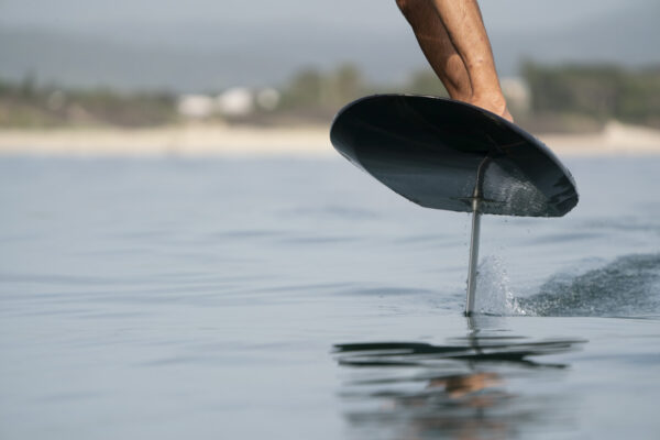 A sleek and innovative Fliteboard Series 3 electric hydrofoil board gliding smoothly on water, with a rider confidently balancing on the board. The board features a streamlined design, an electric propulsion system, and a durable construction, providing an exciting and eco-friendly water sports experience.